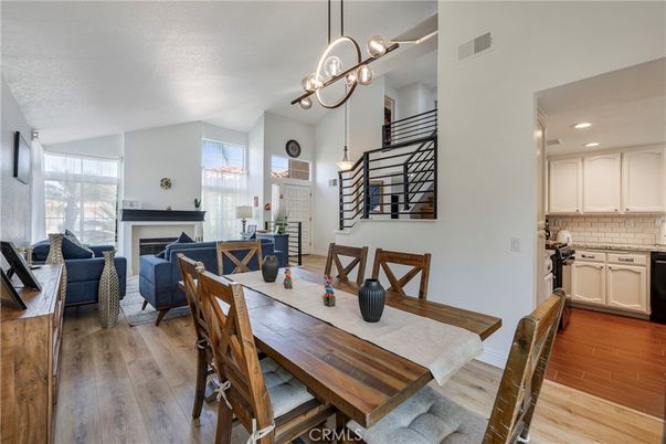 Dining room, Fireplace, Interior, Living room, Pendant Lights, Recessed Lighting, Wood Texture Flooring