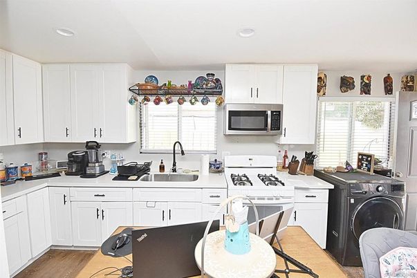 Interior, Kitchen, Recessed Lighting, Washer, Wood Texture Flooring