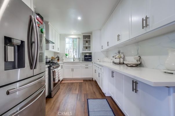 Interior, Kitchen, Marble Walls, Recessed Lighting, Stainless Steel Appliances, Wood Texture Flooring