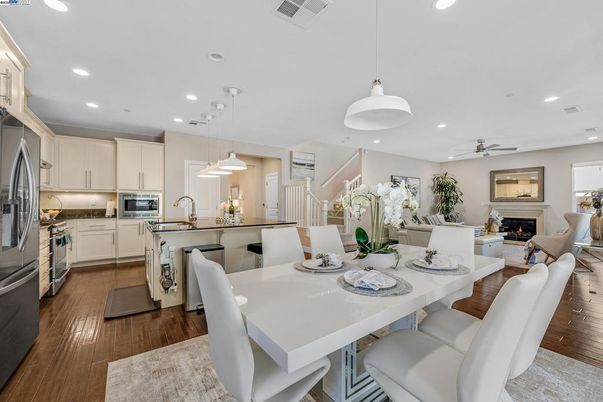 Dining room, Fireplace, Interior, Kitchen, Living room, Pendant Lights, Recessed Lighting, Stainless Steel Appliances, Wood Texture Flooring