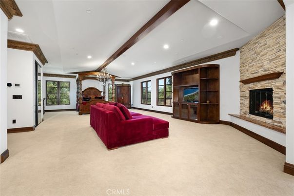 Chandelier, Fireplace, Interior, Living room, Recessed Lighting, Stone Walls, Wooden Beams