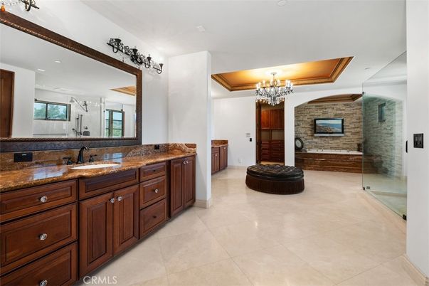 Bathroom, Chandelier, Dual Sink Vanities, Glass Shower, Interior, Recessed Lighting, Stone Walls