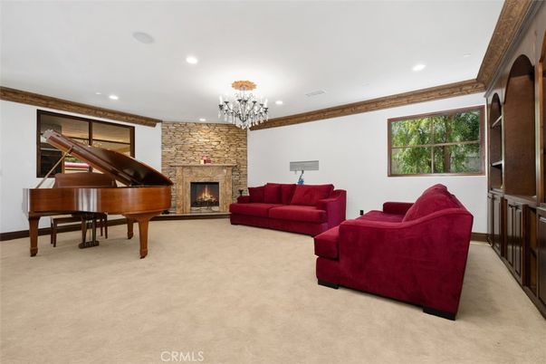 Chandelier, Fireplace, Interior, Living room, Piano, Recessed Lighting, Stone Walls
