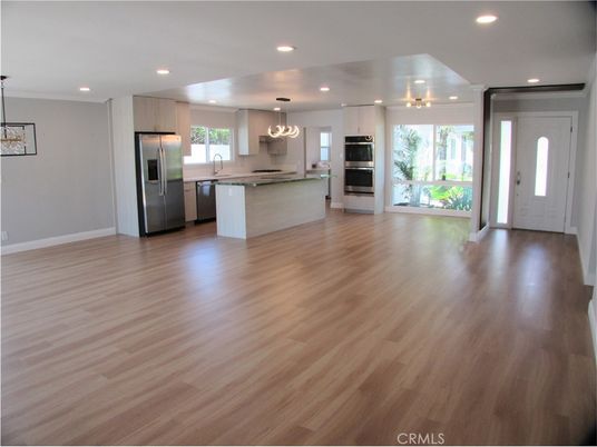 Empty room, Interior, Kitchen, Pendant Lights, Recessed Lighting, Stainless Steel Appliances, Wood Texture Flooring