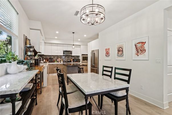 Chandelier, Dining room, Interior, Kitchen, Pendant Lights, Recessed Lighting, Stainless Steel Appliances, Wood Texture Flooring