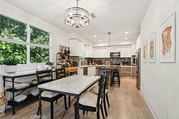 Chandelier, Dining room, Interior, Kitchen, Pendant Lights, Recessed Lighting, Stainless Steel Appliances, Wood Texture Flooring