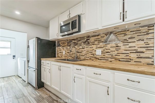 Interior, Kitchen, Recessed Lighting, Washer, Wood Texture Flooring