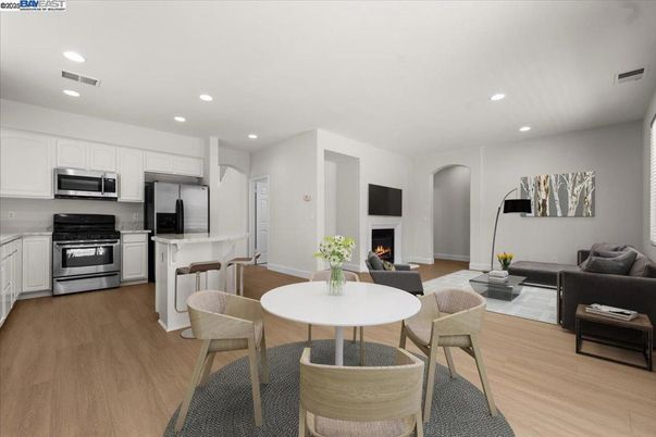 Dining room, Fireplace, Interior, Kitchen, Living room, Recessed Lighting, Stainless Steel Appliances, Wood Texture Flooring