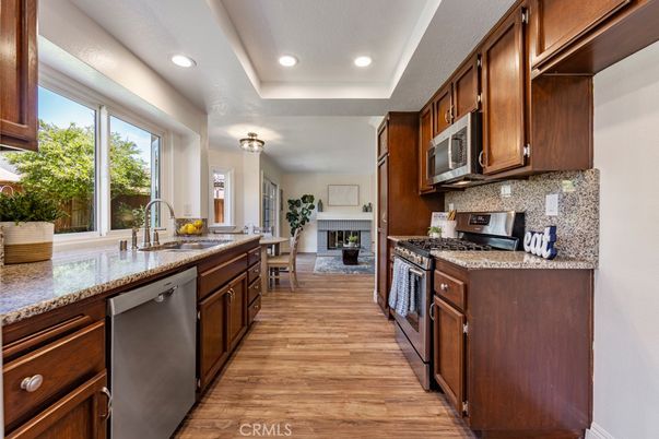 Dining room, Fireplace, Interior, Kitchen, Recessed Lighting, Stainless Steel Appliances, Wood Texture Flooring