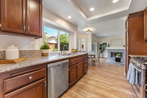 Dining room, Fireplace, Interior, Kitchen, Recessed Lighting, Stainless Steel Appliances, Wood Texture Flooring