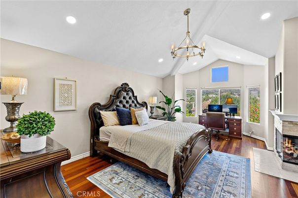 Bedroom, Chandelier, Fireplace, Interior, Recessed Lighting, Wood Texture Flooring