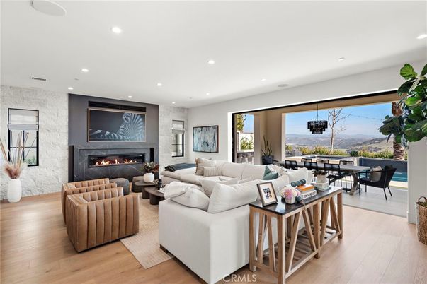Dining room, Fireplace, Interior, Living room, Pendant Lights, Recessed Lighting, Wood Texture Flooring