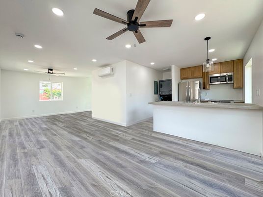 Empty room, Interior, Kitchen, Pendant Lights, Recessed Lighting, Stainless Steel Appliances, Wood Texture Flooring