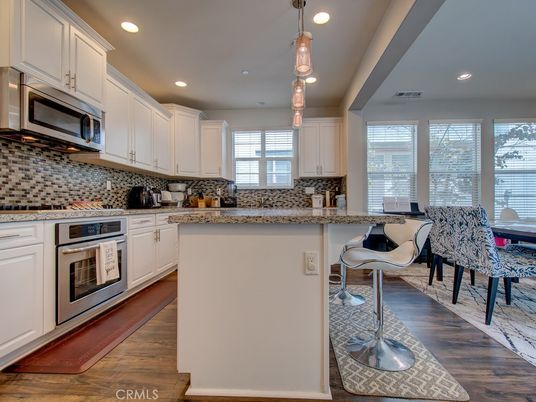 Dining room, Interior, Kitchen, Pendant Lights, Recessed Lighting, Stainless Steel Appliances, Wood Texture Flooring