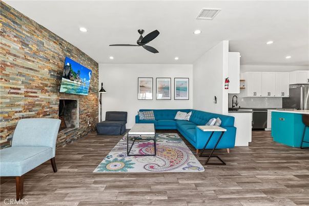 Fireplace, Interior, Kitchen, Living room, Recessed Lighting, Stainless Steel Appliances, Stone Walls, Wood Texture Flooring