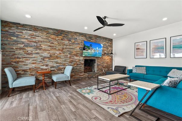 Fireplace, Interior, Living room, Recessed Lighting, Stone Walls, Wood Texture Flooring