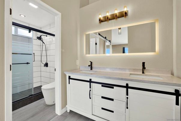 Bathroom, Dual Sink Vanities, Glass Shower, Interior, Recessed Lighting, Wood Texture Flooring