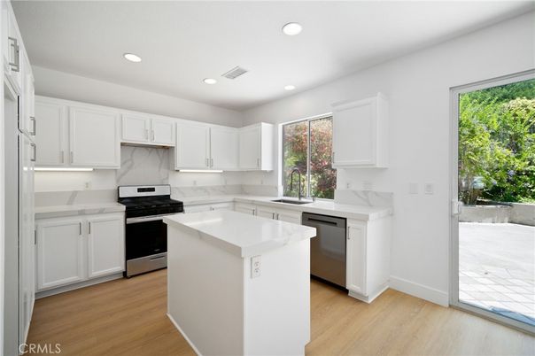 Interior, Kitchen, Marble Walls, Recessed Lighting, Stainless Steel Appliances, Wood Texture Flooring