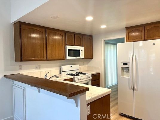 Interior, Kitchen, Recessed Lighting, Tile Countertops, Wood Texture Flooring