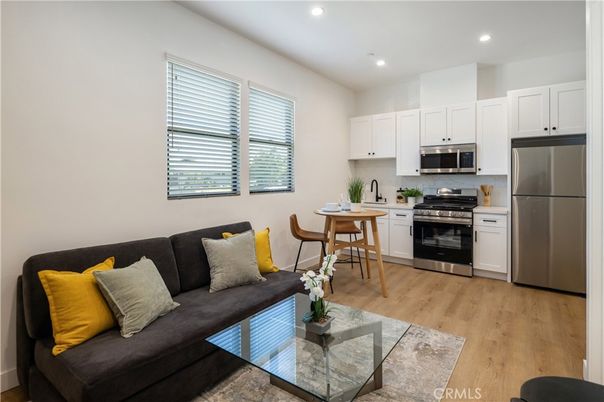 Dining room, Interior, Kitchen, Living room, Recessed Lighting, Stainless Steel Appliances, Wood Texture Flooring