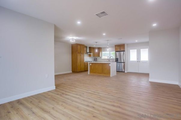 Empty room, Interior, Kitchen, Pendant Lights, Recessed Lighting, Stainless Steel Appliances, Wood Texture Flooring
