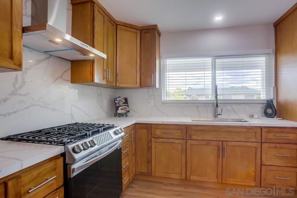 Interior, Kitchen, Marble Walls, Recessed Lighting, Stainless Steel Appliances, Wood Texture Flooring