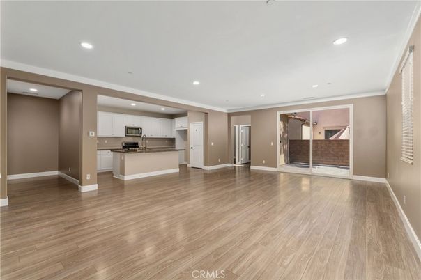 Empty room, Interior, Kitchen, Recessed Lighting, Stainless Steel Appliances, Wood Texture Flooring