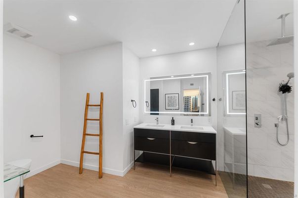 Bathroom, Dual Sink Vanities, Glass Shower, Interior, Marble Walls, Recessed Lighting, Wood Texture Flooring