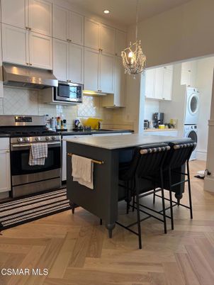 Chandelier, Interior, Kitchen, Pendant Lights, Recessed Lighting, Stainless Steel Appliances, Washer, Wood Texture Flooring