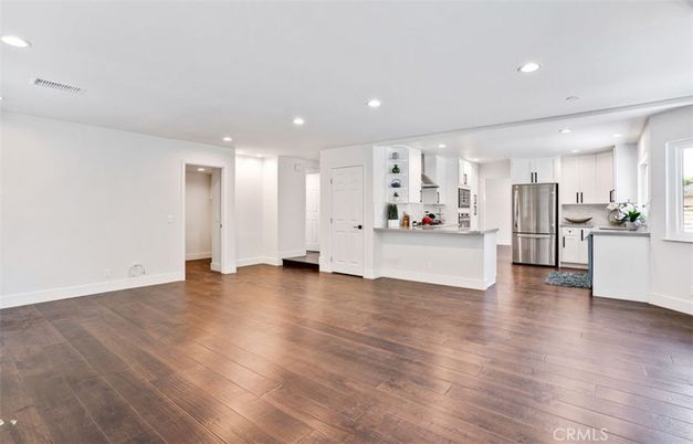 Empty room, Interior, Kitchen, Recessed Lighting, Stainless Steel Appliances, Wood Texture Flooring