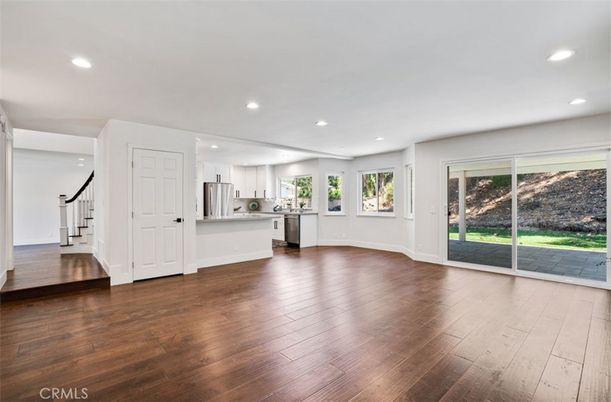 Empty room, Interior, Kitchen, Recessed Lighting, Stainless Steel Appliances, Wood Texture Flooring