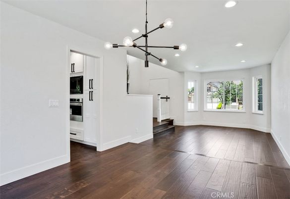 Empty room, Interior, Kitchen, Pendant Lights, Recessed Lighting, Stainless Steel Appliances, Wood Texture Flooring