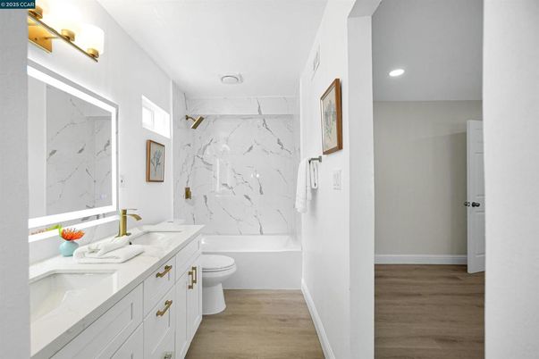 Bathroom, Dual Sink Vanities, Interior, Marble Walls, Recessed Lighting, Wood Texture Flooring