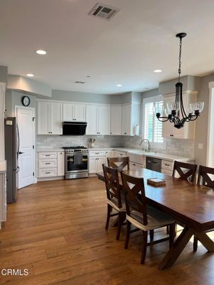 Chandelier, Dining room, Interior, Kitchen, Pendant Lights, Recessed Lighting, Stainless Steel Appliances, Wood Texture Flooring