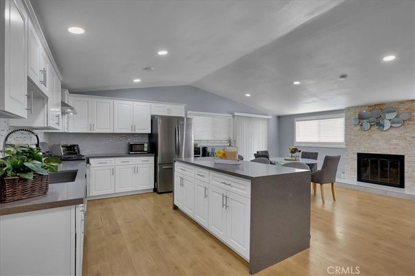 Dining room, Fireplace, Interior, Kitchen, Recessed Lighting, Stainless Steel Appliances, Stone Walls, Wood Texture Flooring