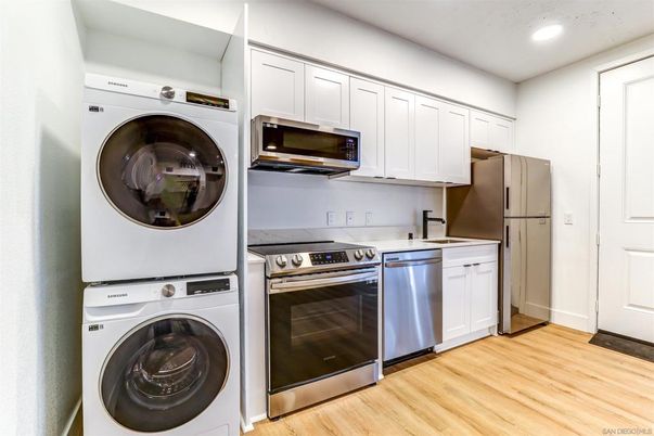 Interior, Kitchen, Recessed Lighting, Stainless Steel Appliances, Washer, Wood Texture Flooring