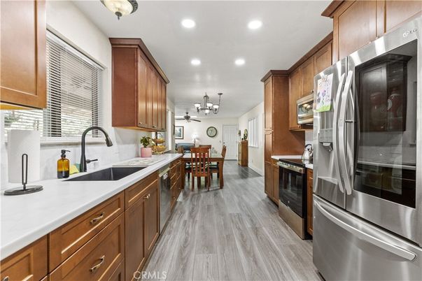 Chandelier, Dining room, Interior, Kitchen, Pendant Lights, Recessed Lighting, Stainless Steel Appliances, Wood Texture Flooring