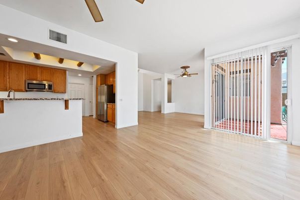 Empty room, Interior, Kitchen, Recessed Lighting, Stainless Steel Appliances, Wood Texture Flooring