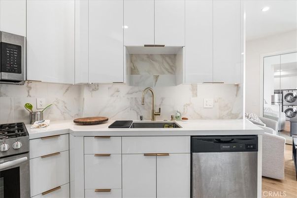Interior, Kitchen, Marble Walls, Recessed Lighting, Stainless Steel Appliances, Wood Texture Flooring