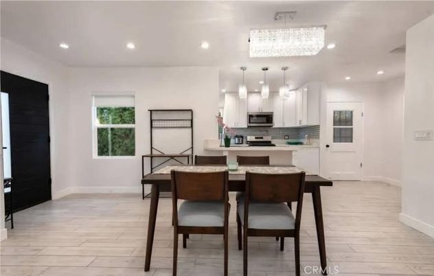 Chandelier, Dining room, Interior, Kitchen, Pendant Lights, Recessed Lighting, Stainless Steel Appliances, Wood Texture Flooring