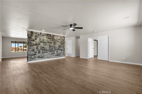 Empty room, Fireplace, Interior, Recessed Lighting, Stone Walls, Wood Texture Flooring
