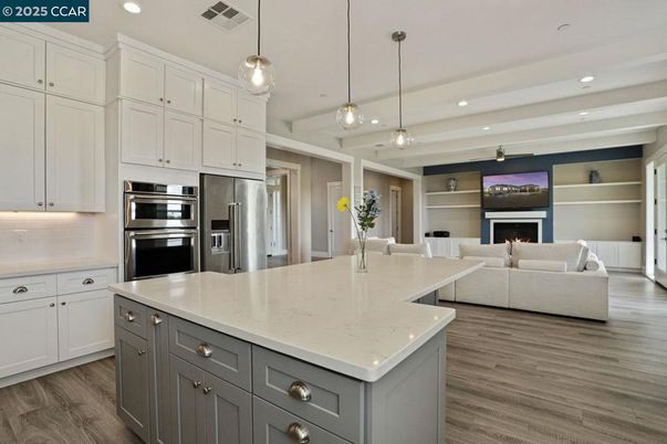 Fireplace, Interior, Kitchen, Living room, Pendant Lights, Recessed Lighting, Stainless Steel Appliances, Wood Texture Flooring