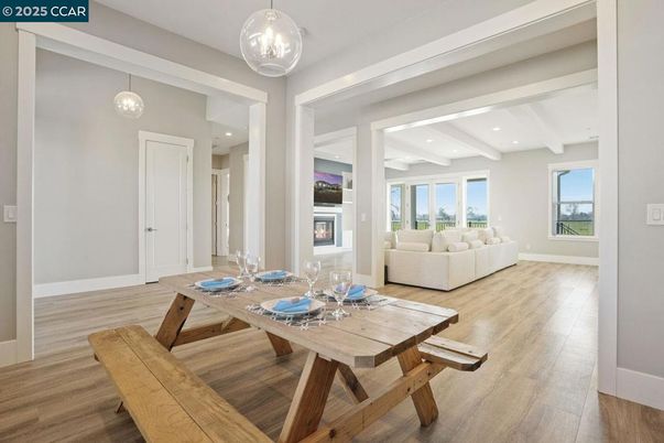 Dining room, Fireplace, Interior, Living room, Pendant Lights, Recessed Lighting, Wood Texture Flooring