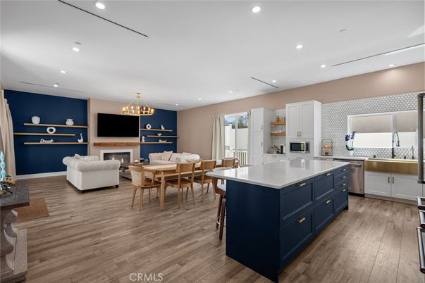 Chandelier, Dining room, Fireplace, Interior, Kitchen, Living room, Pendant Lights, Recessed Lighting, Stainless Steel Appliances, Wood Texture Flooring