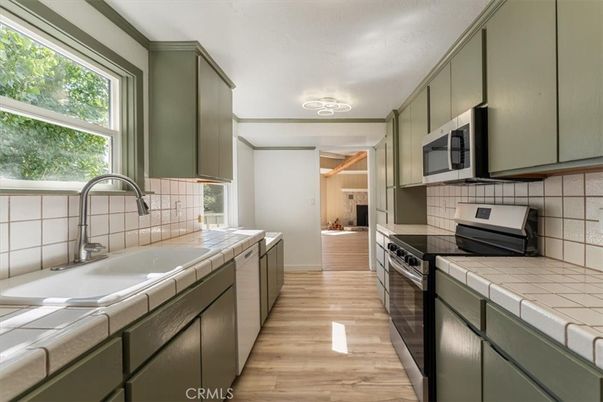 Interior, Kitchen, Stainless Steel Appliances, Tile Countertops, Wood Texture Flooring
