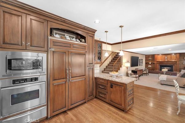 Fireplace, Interior, Kitchen, Living room, Pendant Lights, Recessed Lighting, Stainless Steel Appliances, Wood Texture Flooring