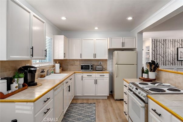 Interior, Kitchen, Recessed Lighting, Tile Countertops, Wood Texture Flooring