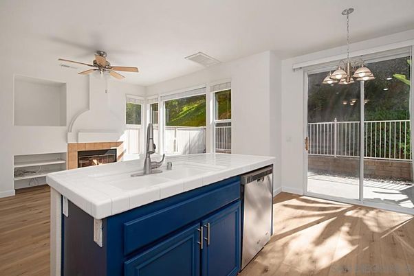 Fireplace, Interior, Kitchen, Pendant Lights, Tile Countertops, Wood Texture Flooring