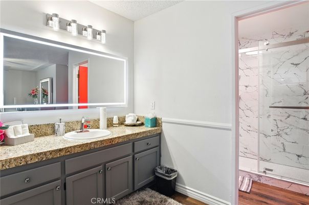Bathroom, Glass Shower, Interior, Marble Walls, Wood Texture Flooring