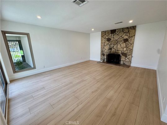 Empty room, Fireplace, Interior, Recessed Lighting, Stone Walls, Wood Texture Flooring